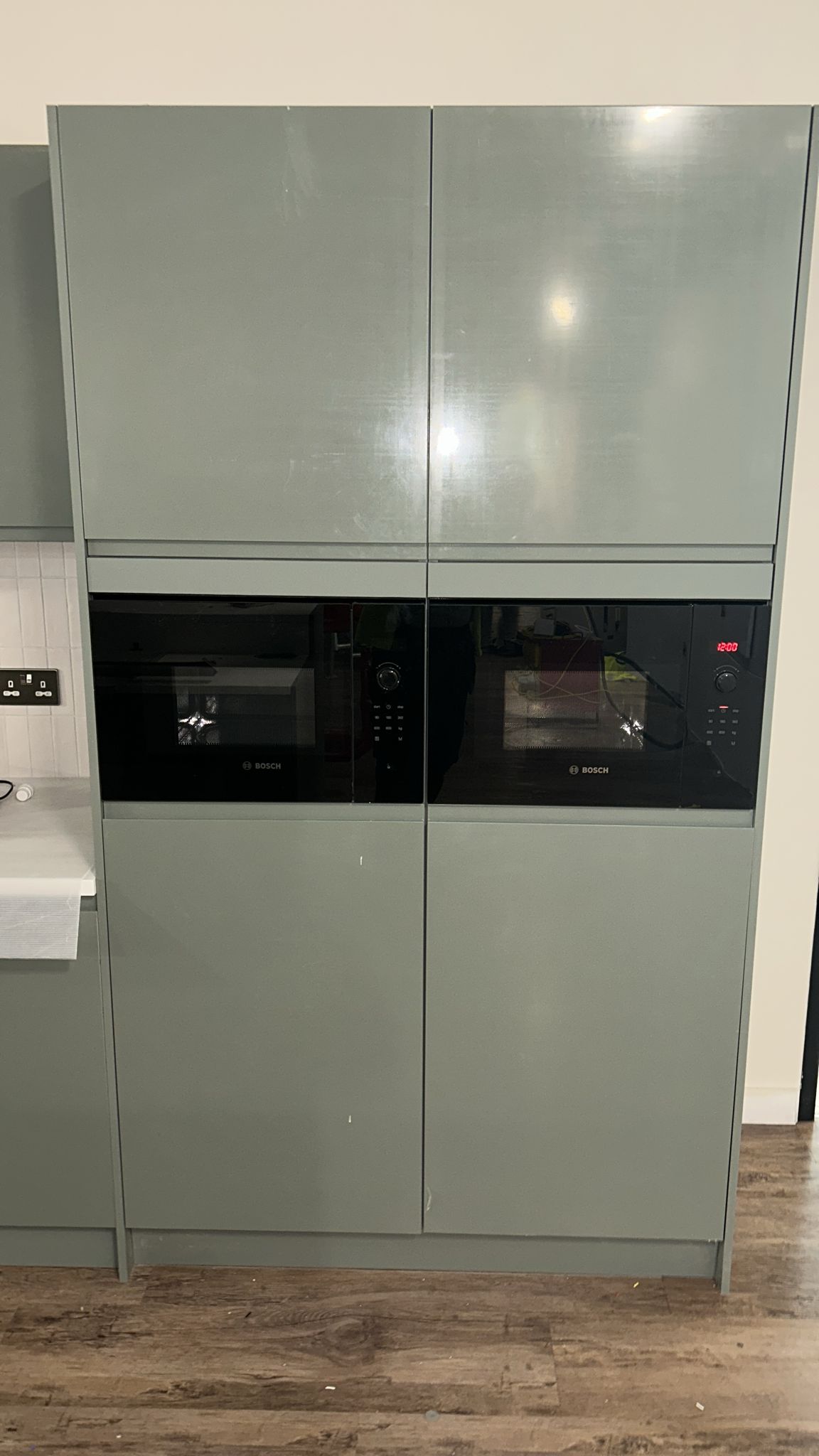 Full-height sage units housing new Bosch built-in oven and microwave